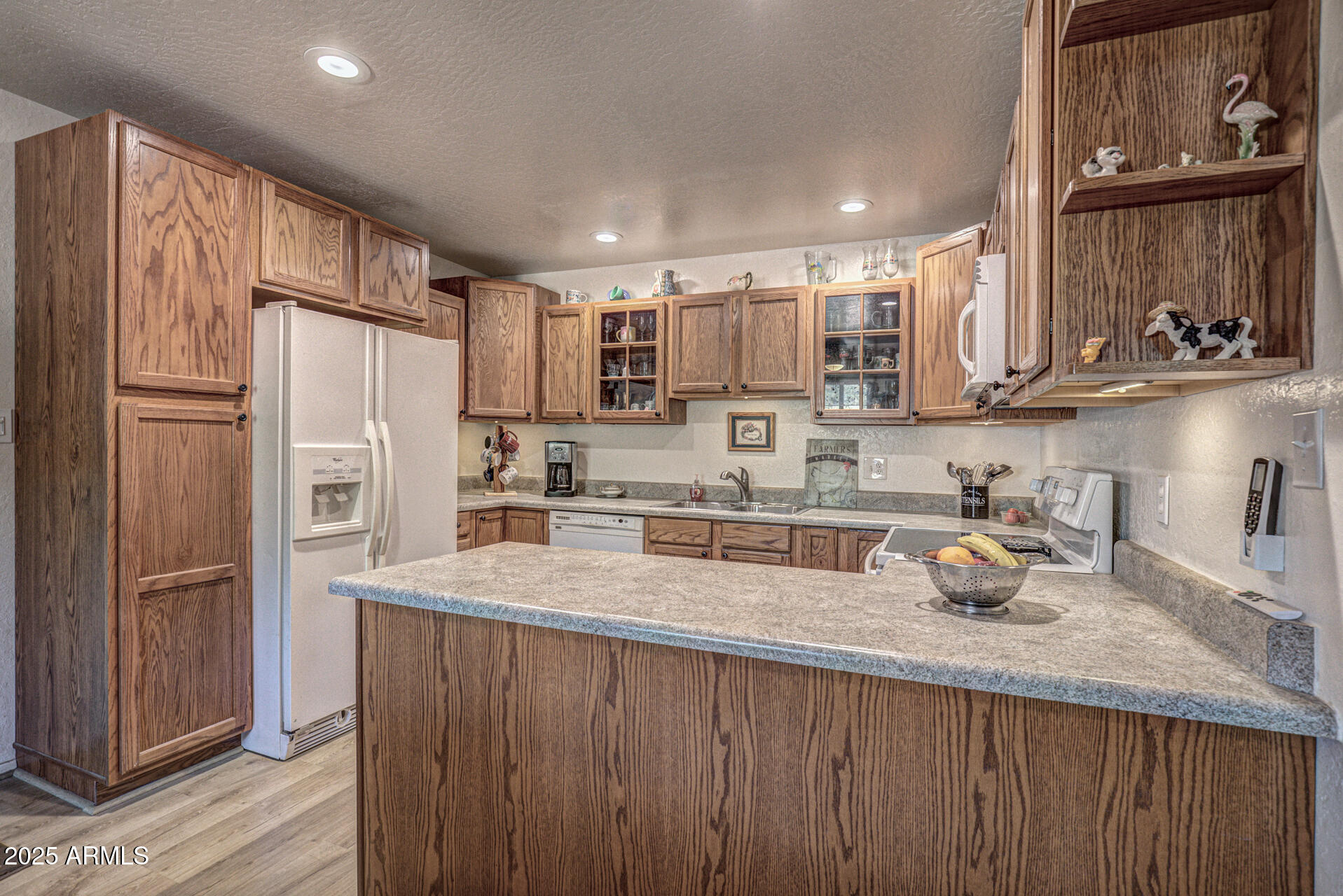 9019 Pinon Lane Pine, AZ 85544 - Photo 6 of 34 a kitchen with a refrigerator a sink and cabinets