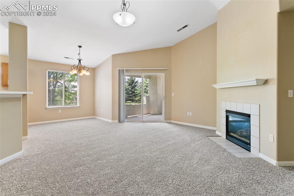 3831 Riviera Grove, Unit 204 Colorado Springs, CO 80922 - Photo 11 of 35 an empty room with windows and fireplace