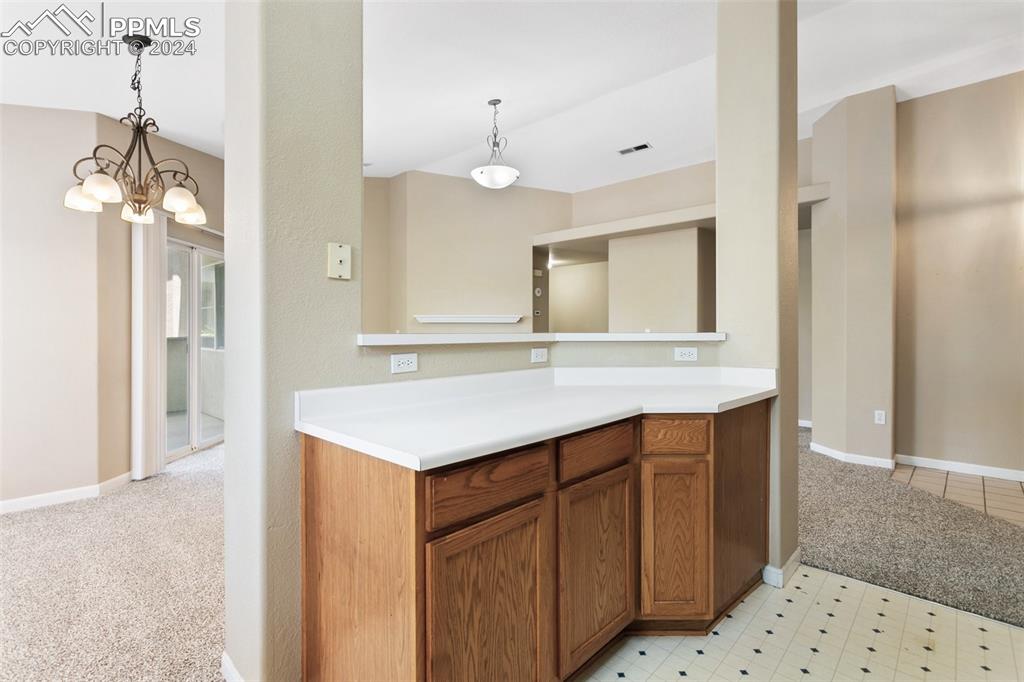 3831 Riviera Grove, Unit 204 Colorado Springs, CO 80922 - Photo 17 of 35 a bathroom with a sink a mirror and a shower
