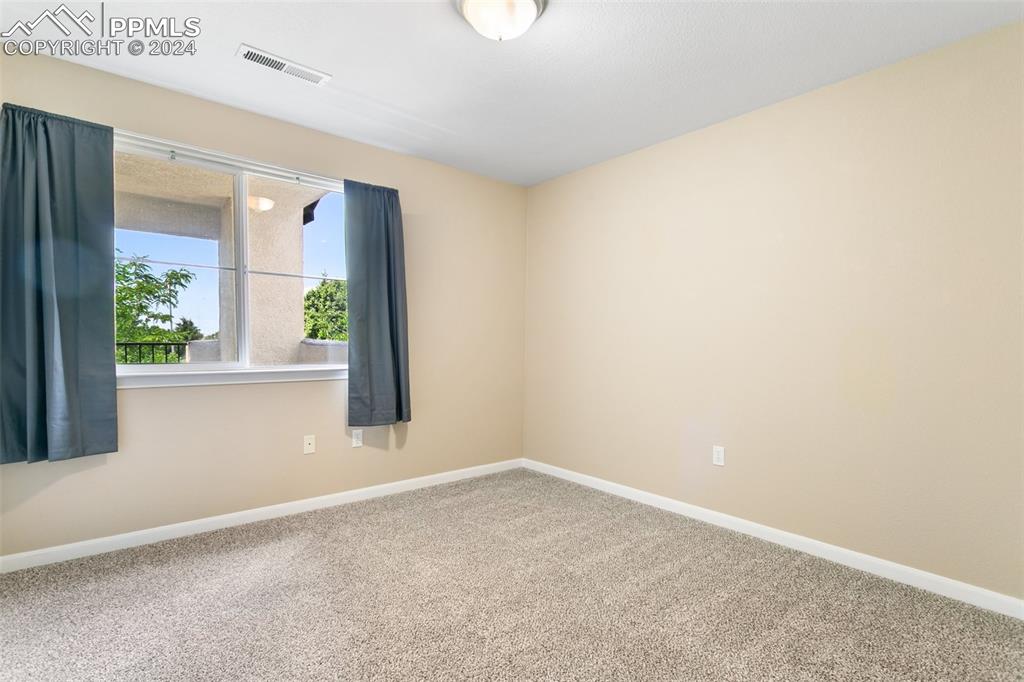 3831 Riviera Grove, Unit 204 Colorado Springs, CO 80922 - Photo 25 of 35 an empty room with windows