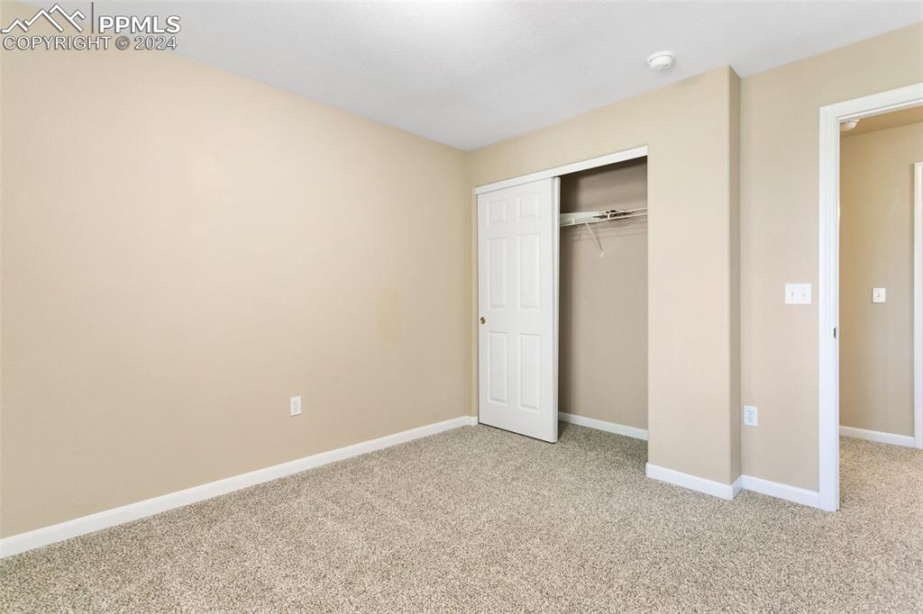 3831 Riviera Grove, Unit 204 Colorado Springs, CO 80922 - Photo 26 of 35 an empty room with closet and a window