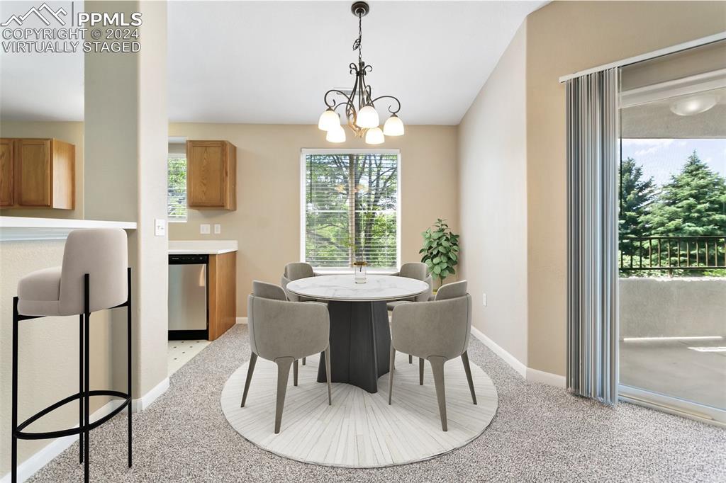 3831 Riviera Grove, Unit 204 Colorado Springs, CO 80922 - Photo 6 of 35 a dining room with furniture a chandelier and wooden floor