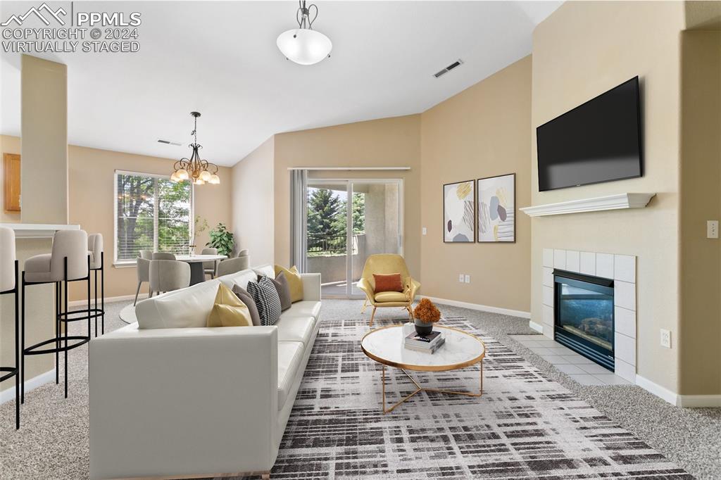 3831 Riviera Grove, Unit 204 Colorado Springs, CO 80922 - Photo 7 of 35 a living room with fireplace furniture and a flat screen tv