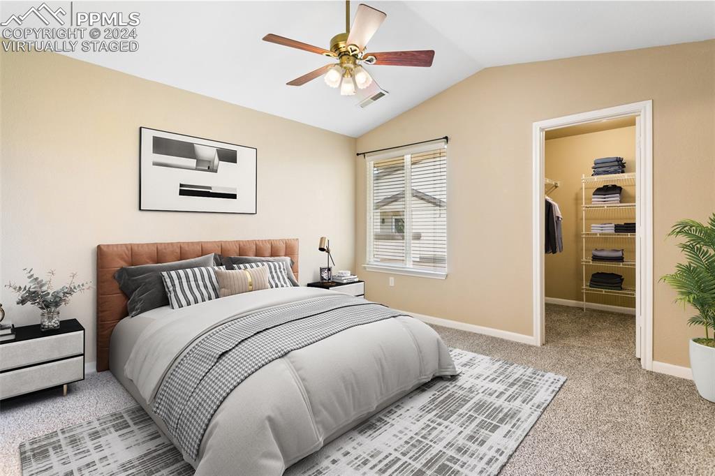 3831 Riviera Grove, Unit 204 Colorado Springs, CO 80922 - Photo 9 of 35 a bedroom with a bed and a chandelier