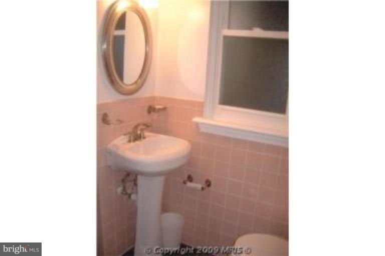 313 Marvin Road Silver Spring, MD 20901 - Photo 18 of 20 1st floor custom tiled full bath w/pedistal sink.