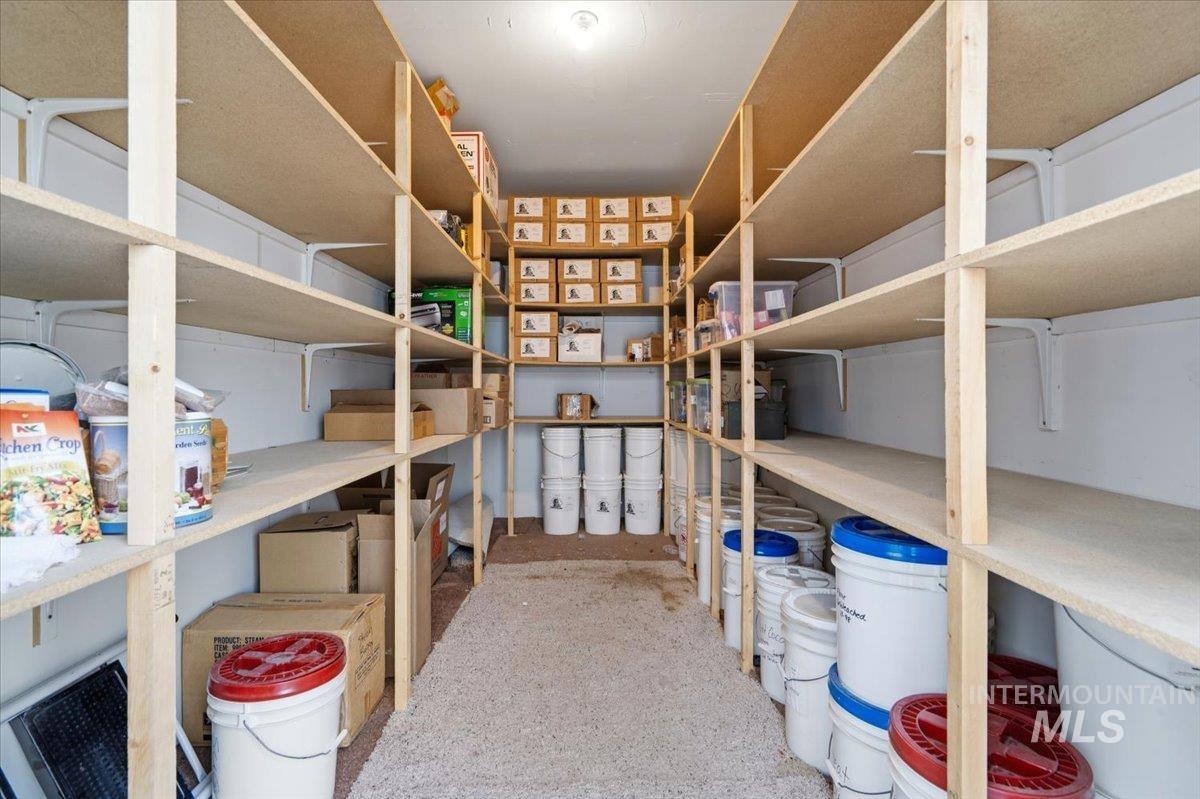 1183 North Buffalo Way Middleton, ID 83644 - Photo 42 of 47 Dedicated storage room featuring extensive built-in shelving, light wood-finish shelving, white wall supports, and overhead lighting