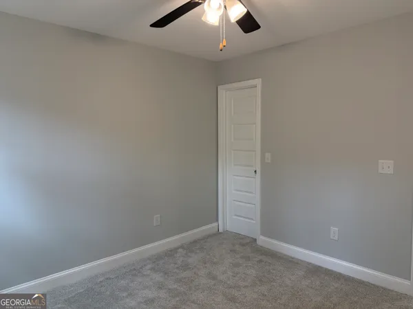 an empty room with a empty space and chandelier fan