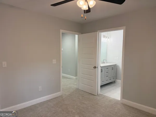 an empty room with chandelier fan