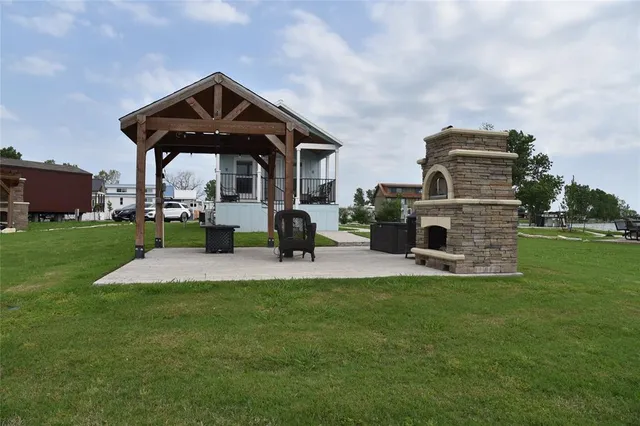 a view of a lake with couches chairs and a yard