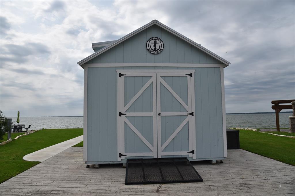 6465 Peninsula Road Kerens, TX 75144 - Photo 30 of 34 a view of a house with yard