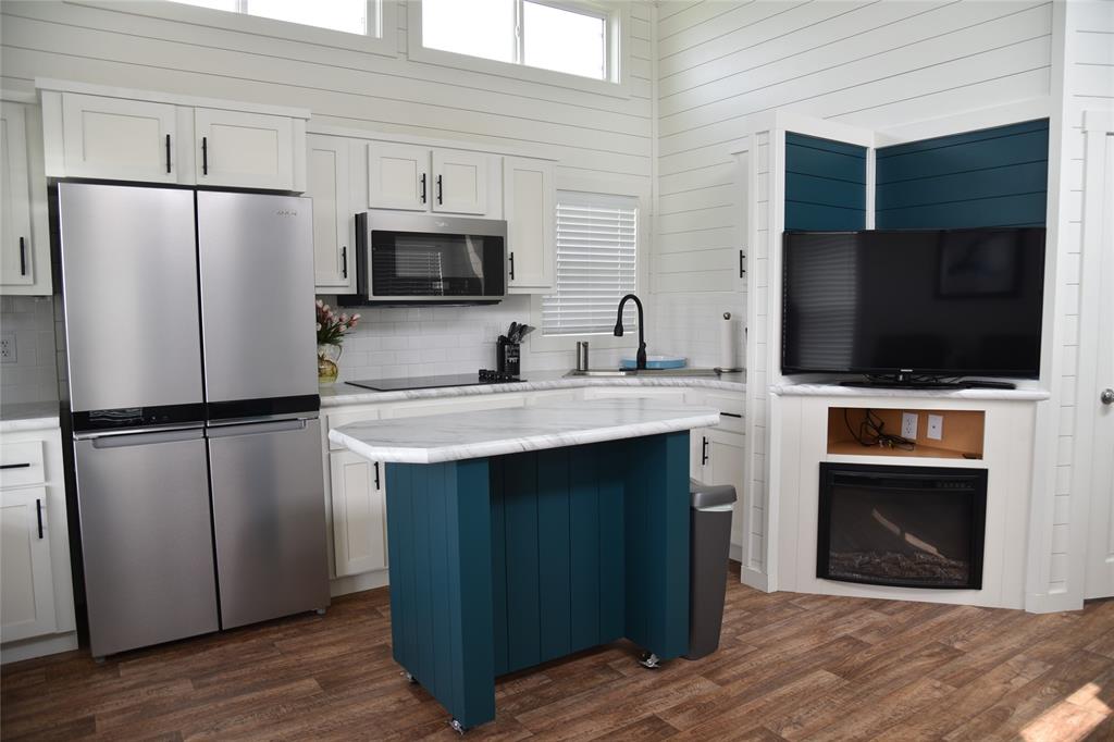 6465 Peninsula Road Kerens, TX 75144 - Photo 5 of 34 a kitchen with stainless steel appliances a refrigerator microwave and sink