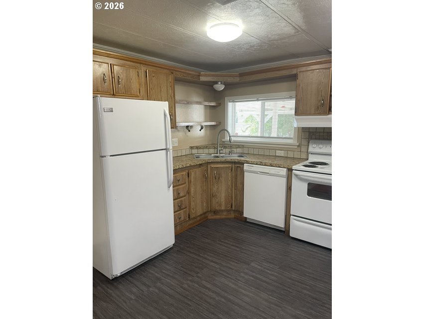 5660 Daisy Street, Unit 31 Springfield, OR 97478 - Photo 42 of 44 a kitchen with a white cabinets and white appliances