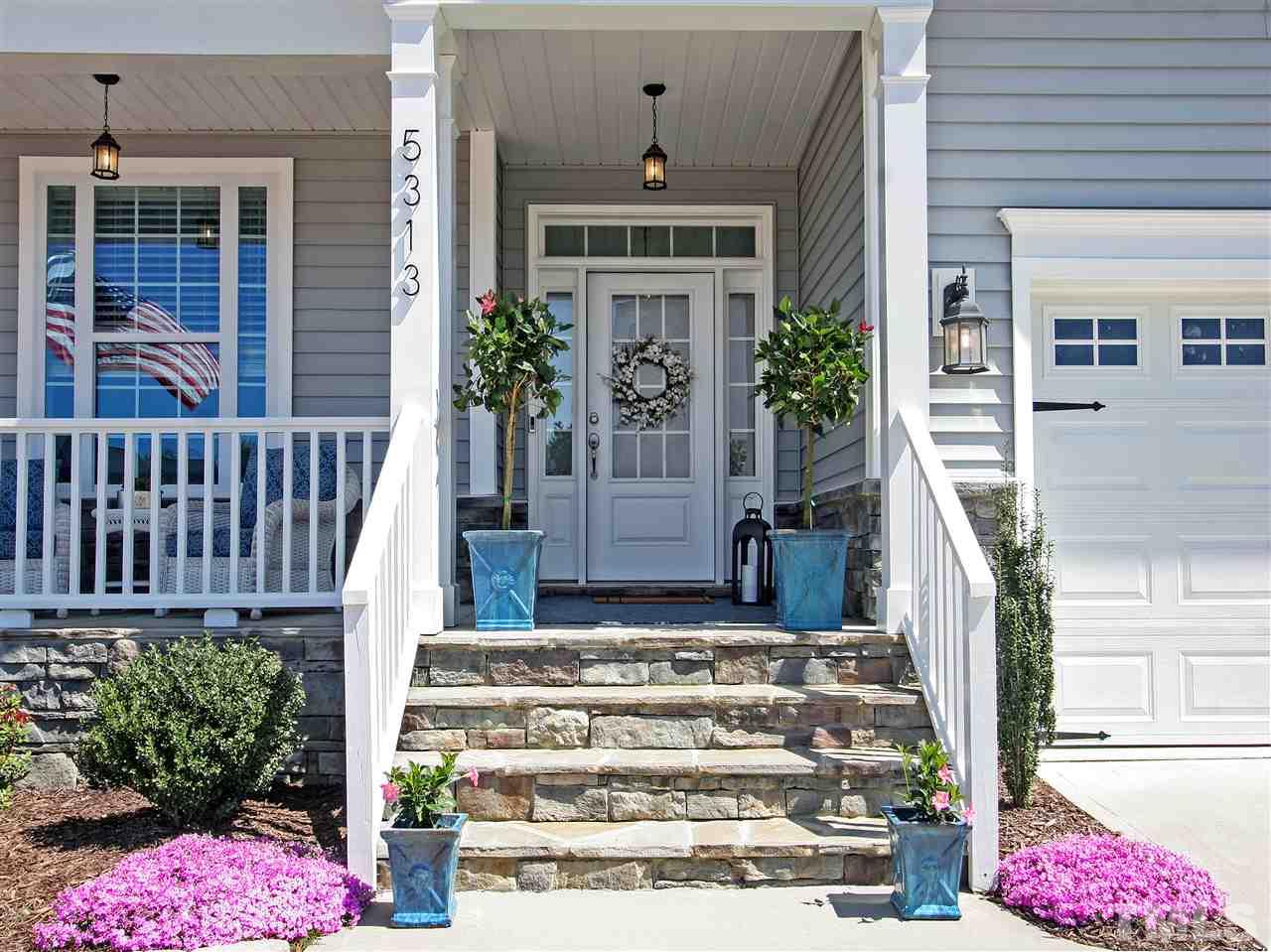 Beautiful front porch greets you and your guests. Stone accents and easy-care vinyl siding. Two-car garage and plenty of driveway parking.