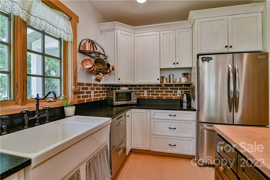 157 Poverty Branch Road Barnardsville, NC 28709 - Photo 13 of 48 a kitchen with stainless steel appliances a stove a refrigerator and a sink