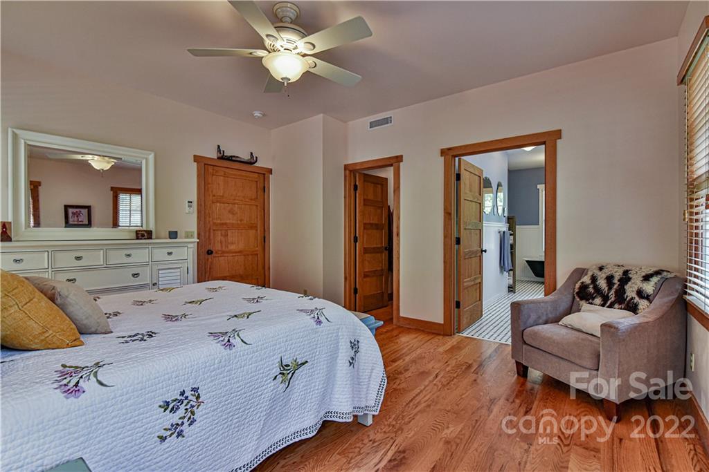 157 Poverty Branch Road Barnardsville, NC 28709 - Photo 21 of 48 a bedroom with a bed and ceiling fan