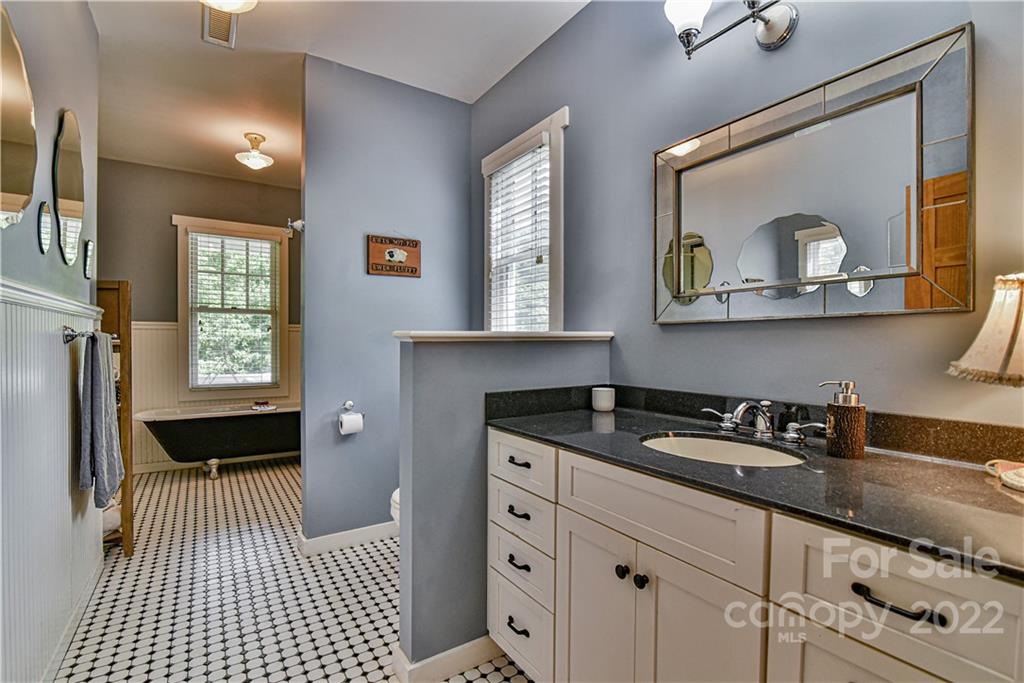 157 Poverty Branch Road Barnardsville, NC 28709 - Photo 22 of 48 a bathroom with a sink a mirror and a window