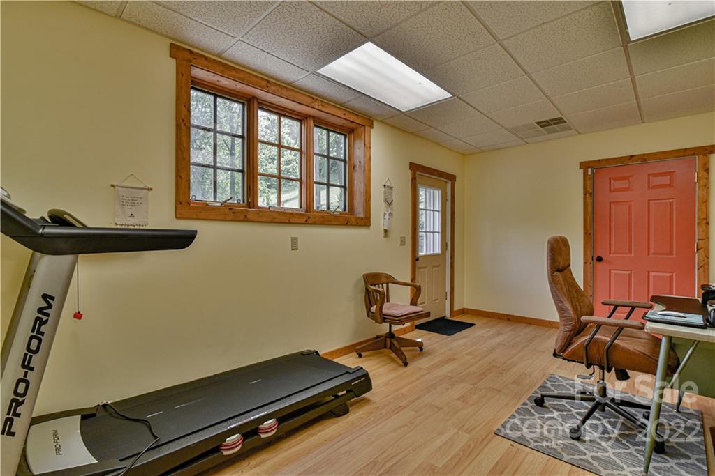 157 Poverty Branch Road Barnardsville, NC 28709 - Photo 33 of 48 a room with gym equipment and windows