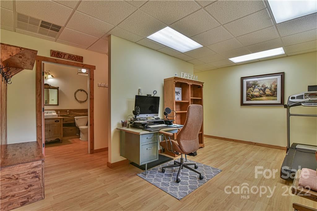 157 Poverty Branch Road Barnardsville, NC 28709 - Photo 34 of 48 a view of a workspace with furniture and wooden floor