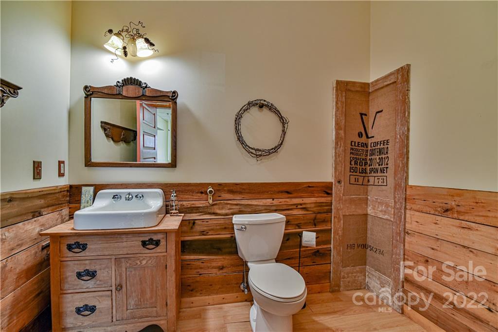 157 Poverty Branch Road Barnardsville, NC 28709 - Photo 35 of 48 a bathroom with a toilet sink and mirror