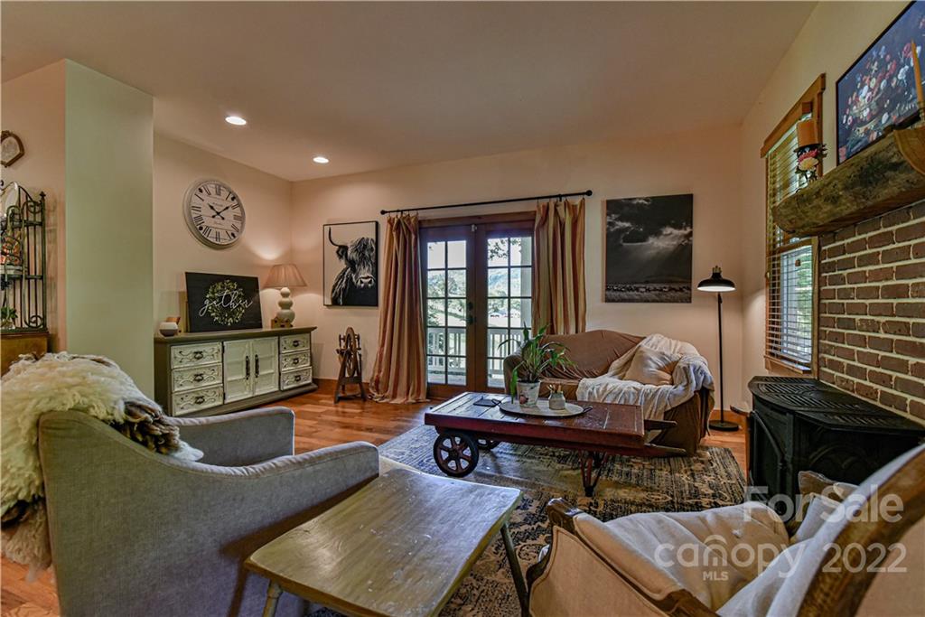 157 Poverty Branch Road Barnardsville, NC 28709 - Photo 8 of 48 a living room with furniture a flat screen tv and a fireplace
