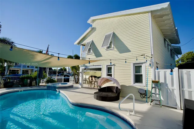 a view of a patio with a table and chairs under an umbrella