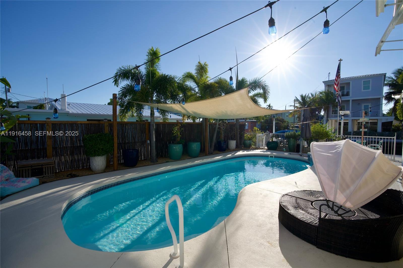 11563 4th Ave Ocean Marathon, FL 33050 - Photo 2 of 15 a view of a white house with a swimming pool and sitting area