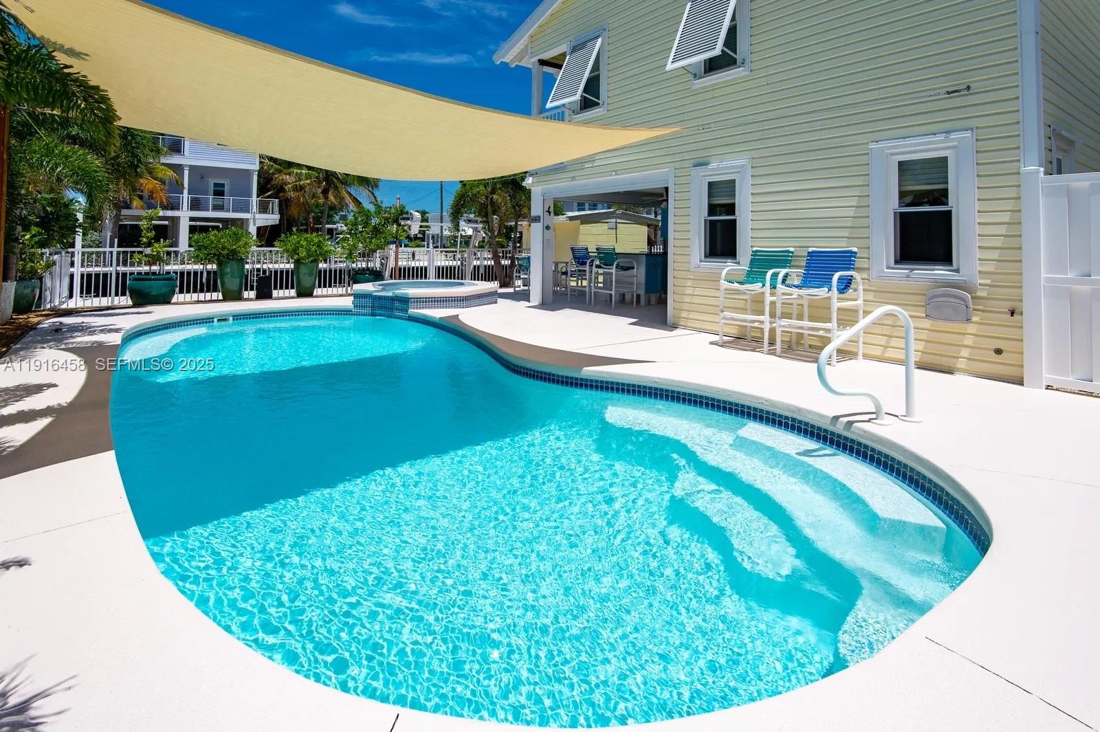 11563 4th Ave Ocean Marathon, FL 33050 - Photo 3 of 15 a view of a swimming pool with a patio