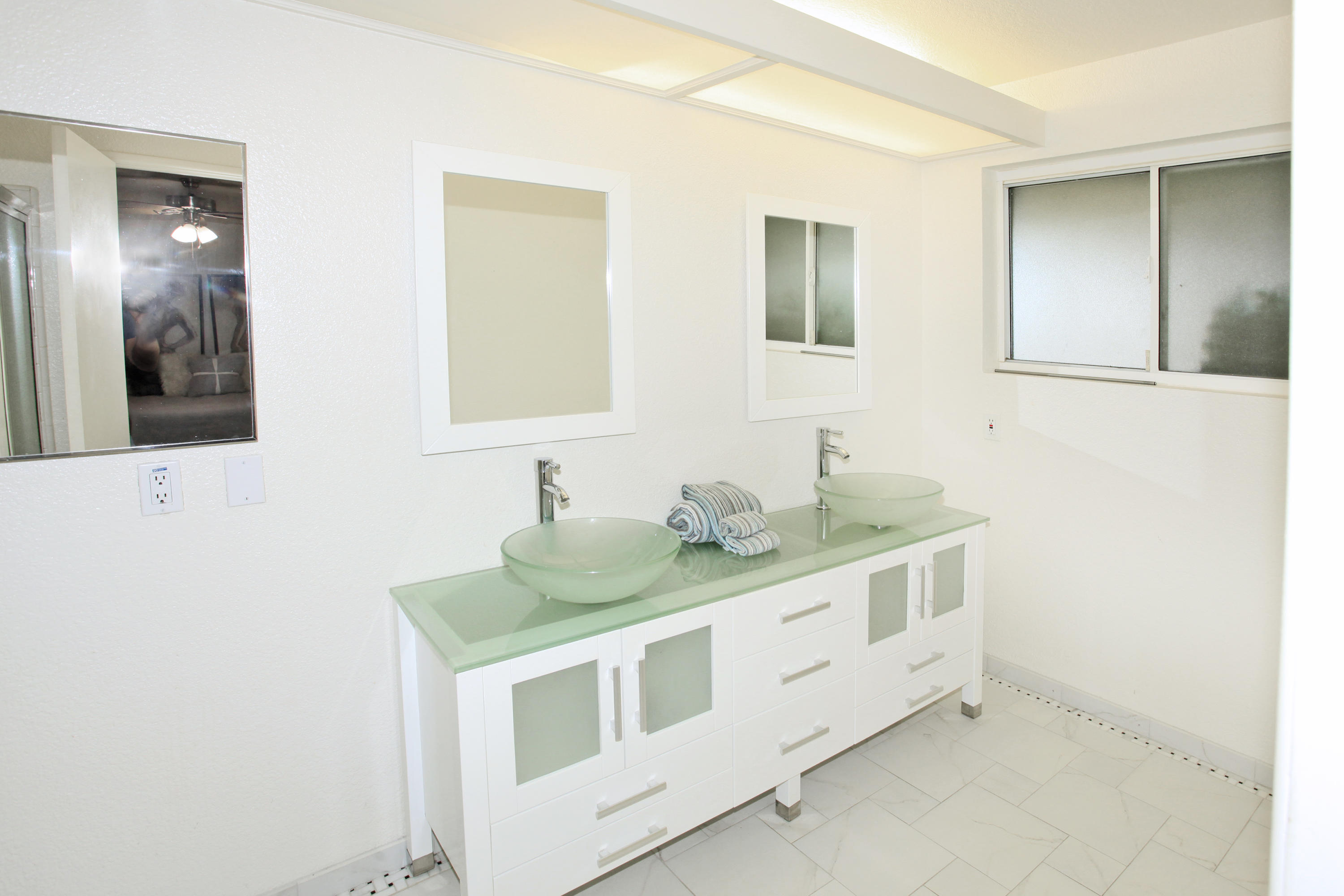 70090 Chappel Road Rancho Mirage, CA 92270 - Photo 17 of 26 a bathroom with double sink and two mirror