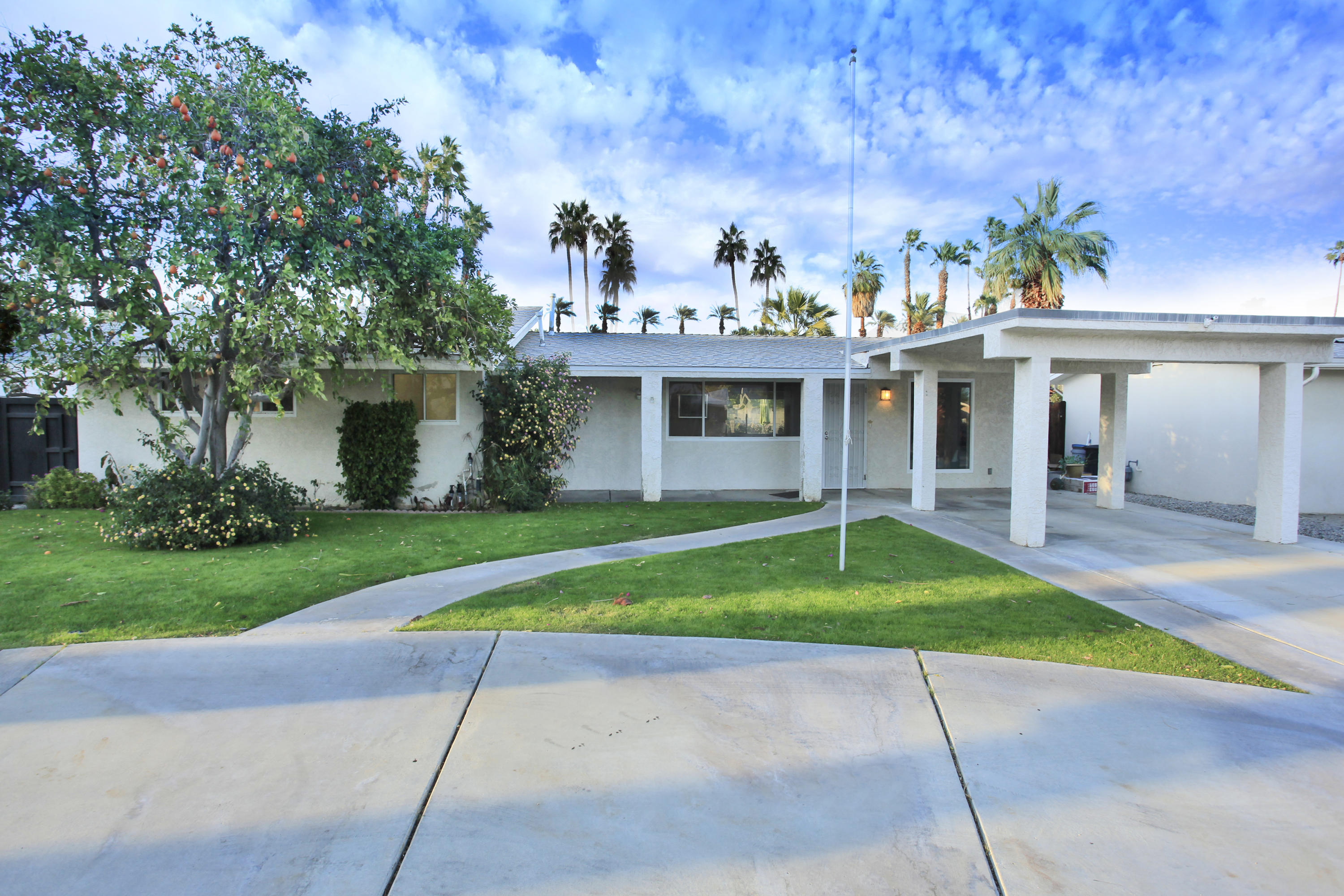 70090 Chappel Road Rancho Mirage, CA 92270 - Photo 22 of 26 a front view of a house with a yard and potted plants