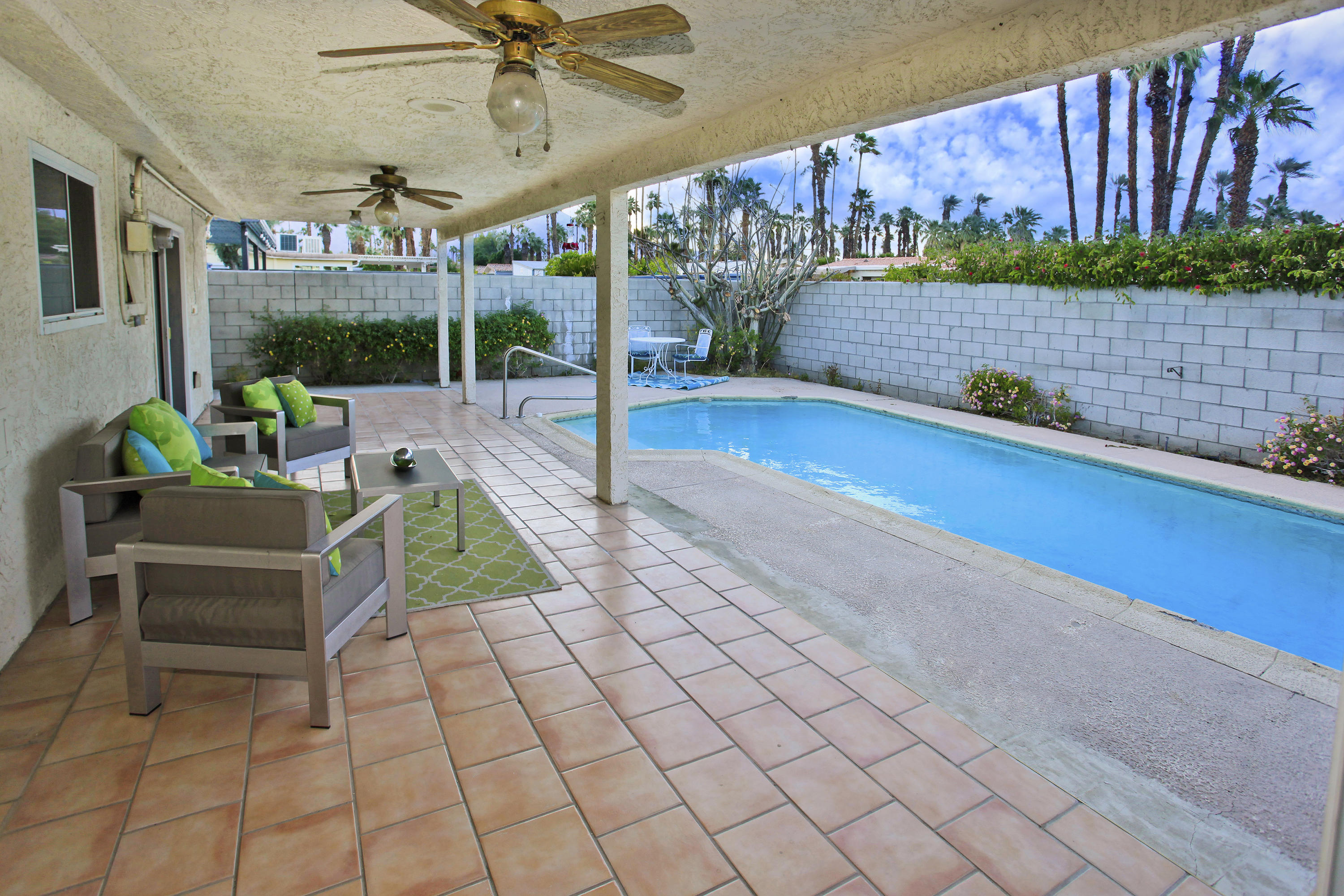 70090 Chappel Road Rancho Mirage, CA 92270 - Photo 23 of 26 a view of a patio with a table chairs and a swimming pool
