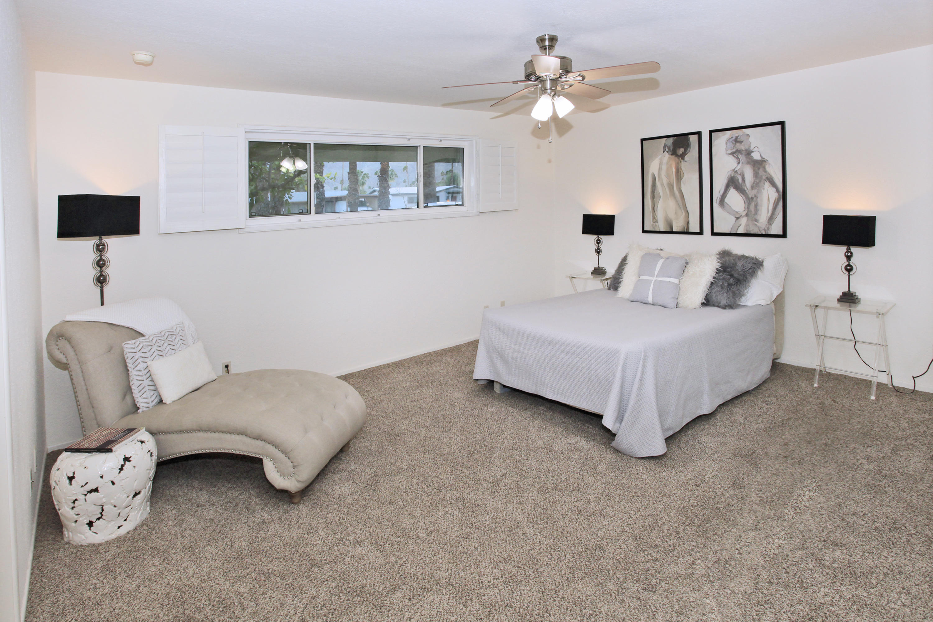 70090 Chappel Road Rancho Mirage, CA 92270 - Photo 7 of 26 a spacious bedroom with a bed a couch and a chandelier