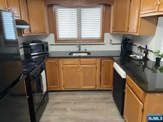 a kitchen with a sink a stove and cabinets
