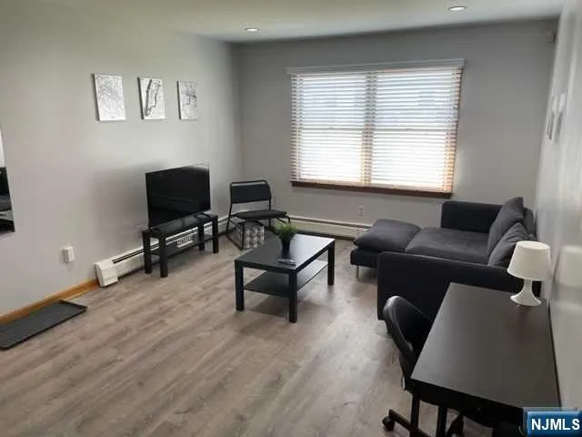 a livingroom with workspace and a couch