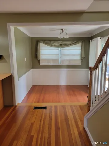 a view of a room with wooden floor and staircase