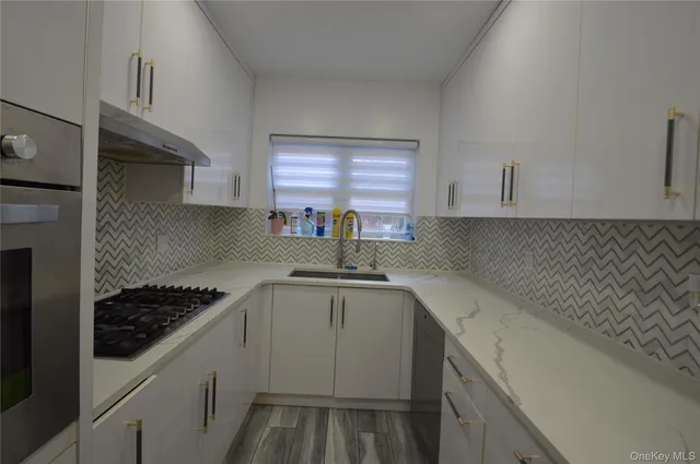 a kitchen with a sink and cabinets