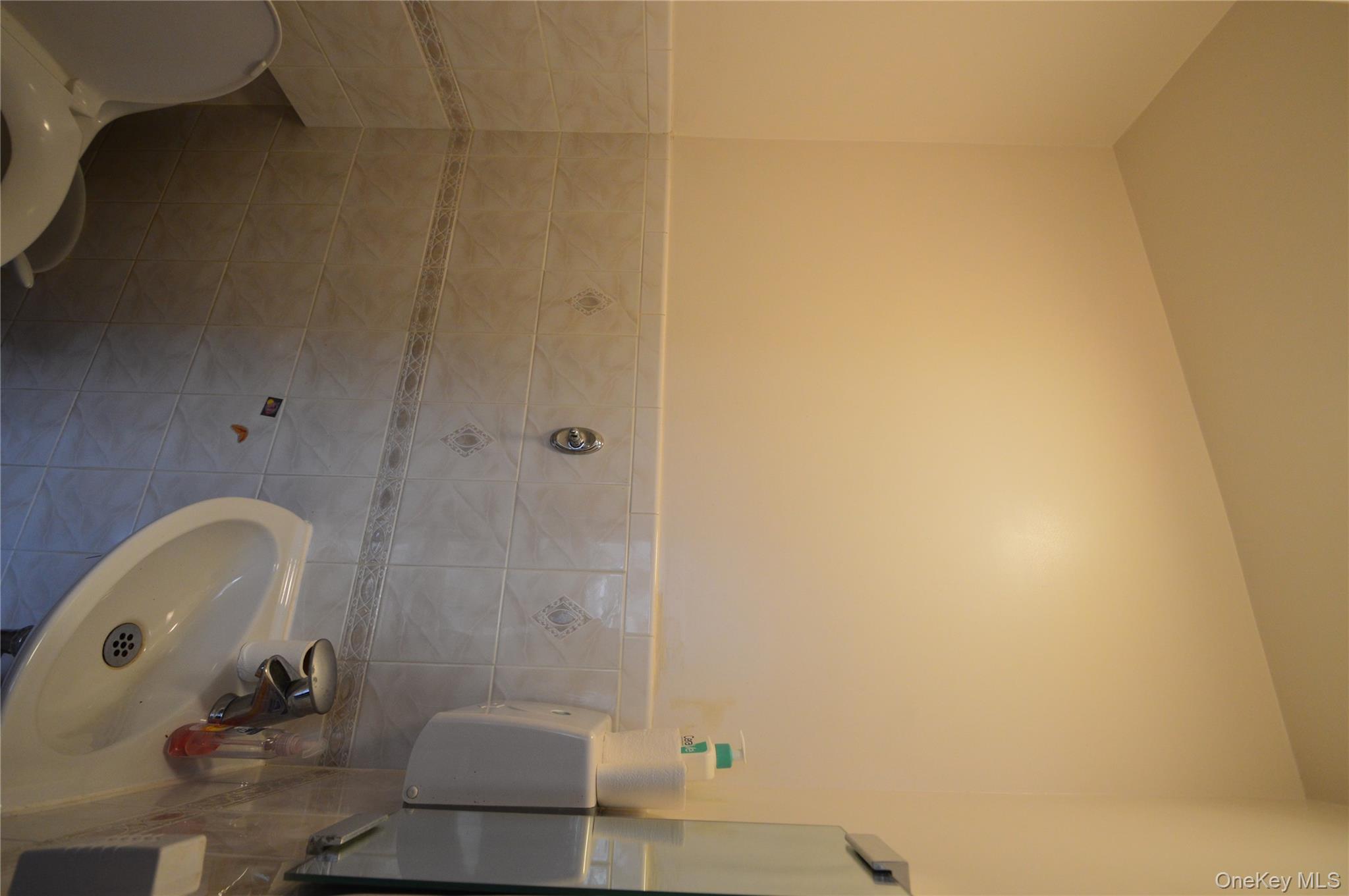 105-46 65th Road Queens, NY 11375 - Photo 13 of 20 a bathroom with a sink and mirror