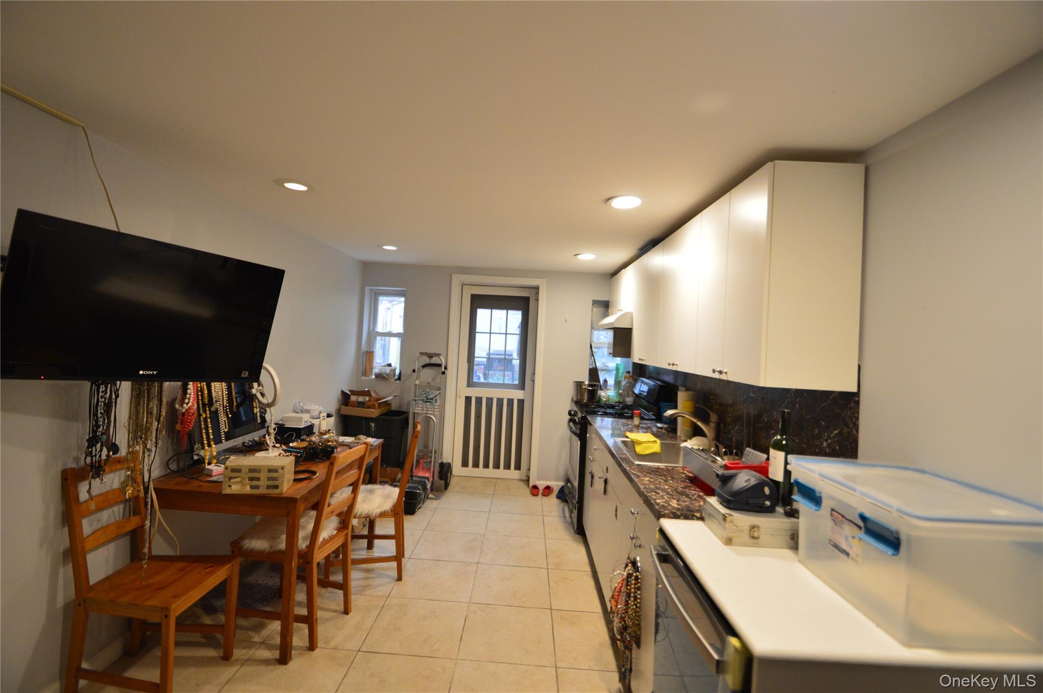 105-46 65th Road Queens, NY 11375 - Photo 17 of 20 a room with furniture and a flat screen tv