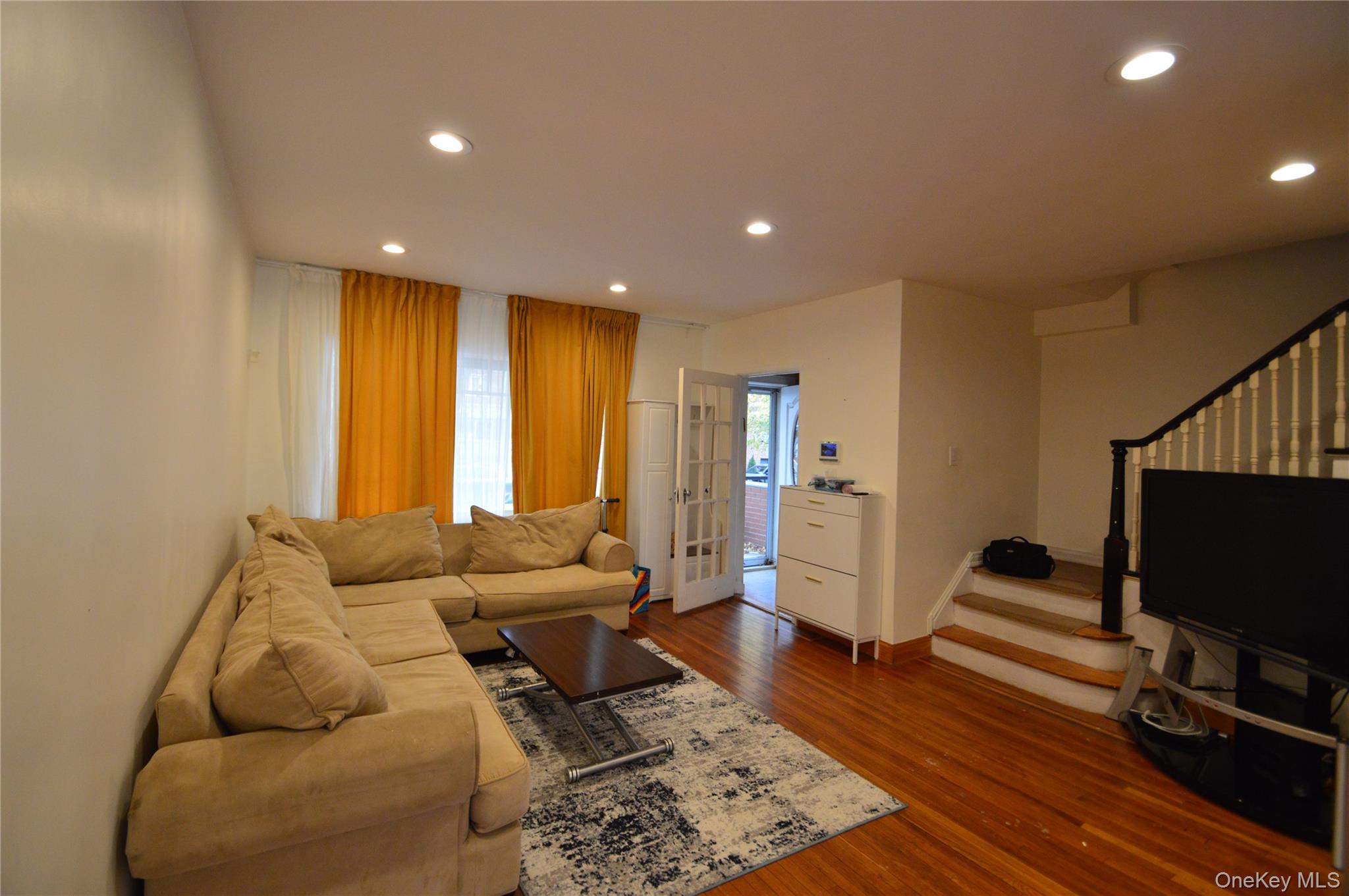 105-46 65th Road Queens, NY 11375 - Photo 19 of 20 a living room with furniture and a flat screen tv