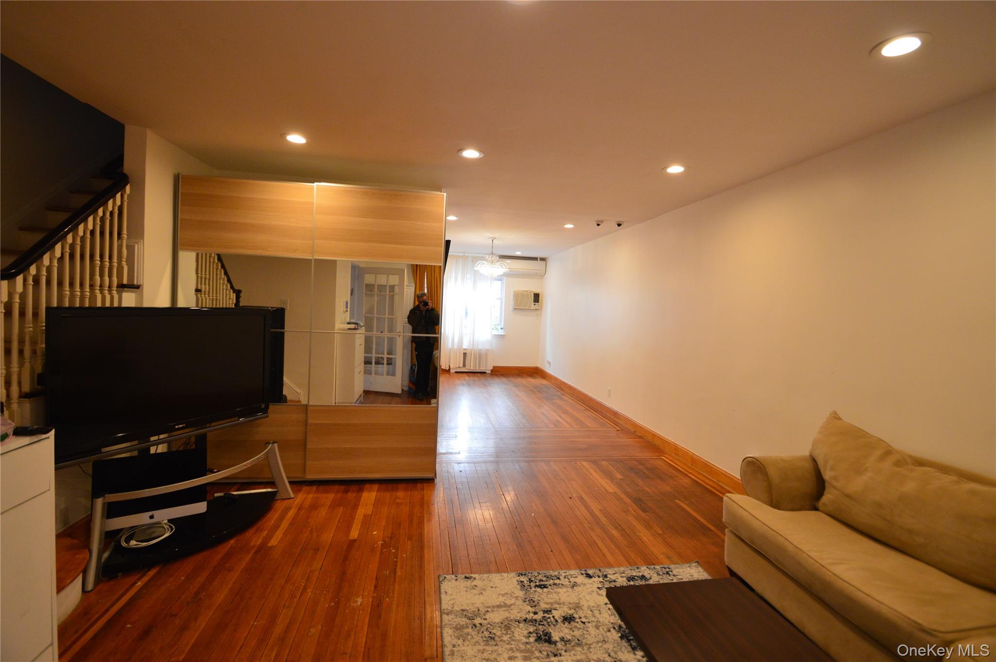 105-46 65th Road Queens, NY 11375 - Photo 8 of 20 a living room with furniture and a flat screen tv