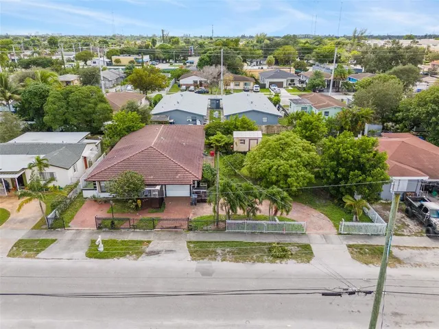 an aerial view of residential houses with green space