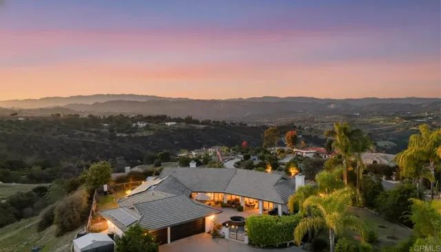 a front view of a house with swimming pool having outdoor seating