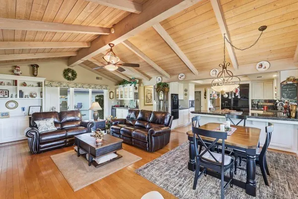 a living room with patio furniture and a wooden floor