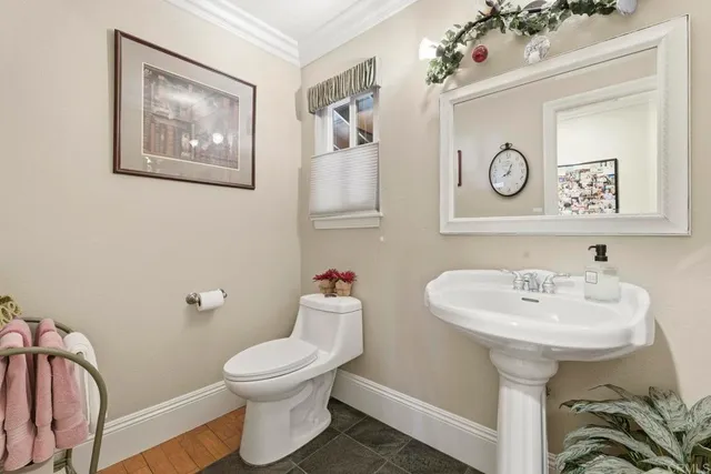 an aerial view of a house with a yard and lake view