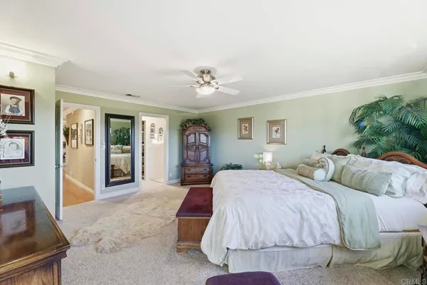 a spacious bedroom with two beds and a chandelier