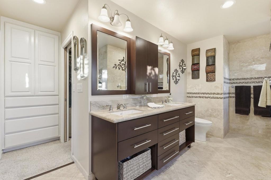 1524 Zutano Lane Fallbrook, CA 92028 - Photo 25 of 49 a bathroom with a granite countertop sink vanity and mirror