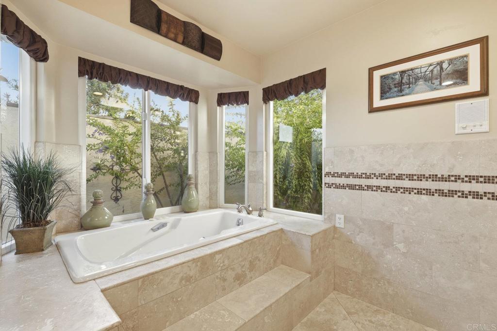 1524 Zutano Lane Fallbrook, CA 92028 - Photo 28 of 49 a large bedroom with a large window and a potted plant