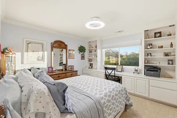 a bedroom with a bed and a large window with the outer view