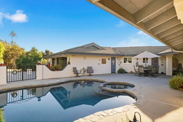 a view of a house with backyard and sitting area