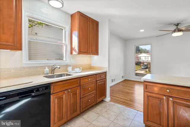 a bathroom with a granite countertop sink a mirror and a bathtub