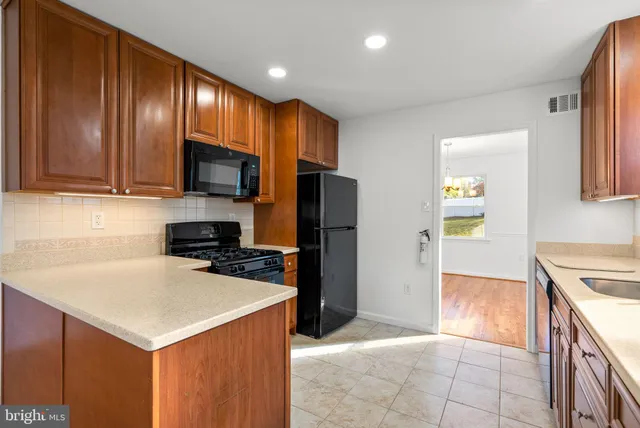 a kitchen with a stove a refrigerator and a sink